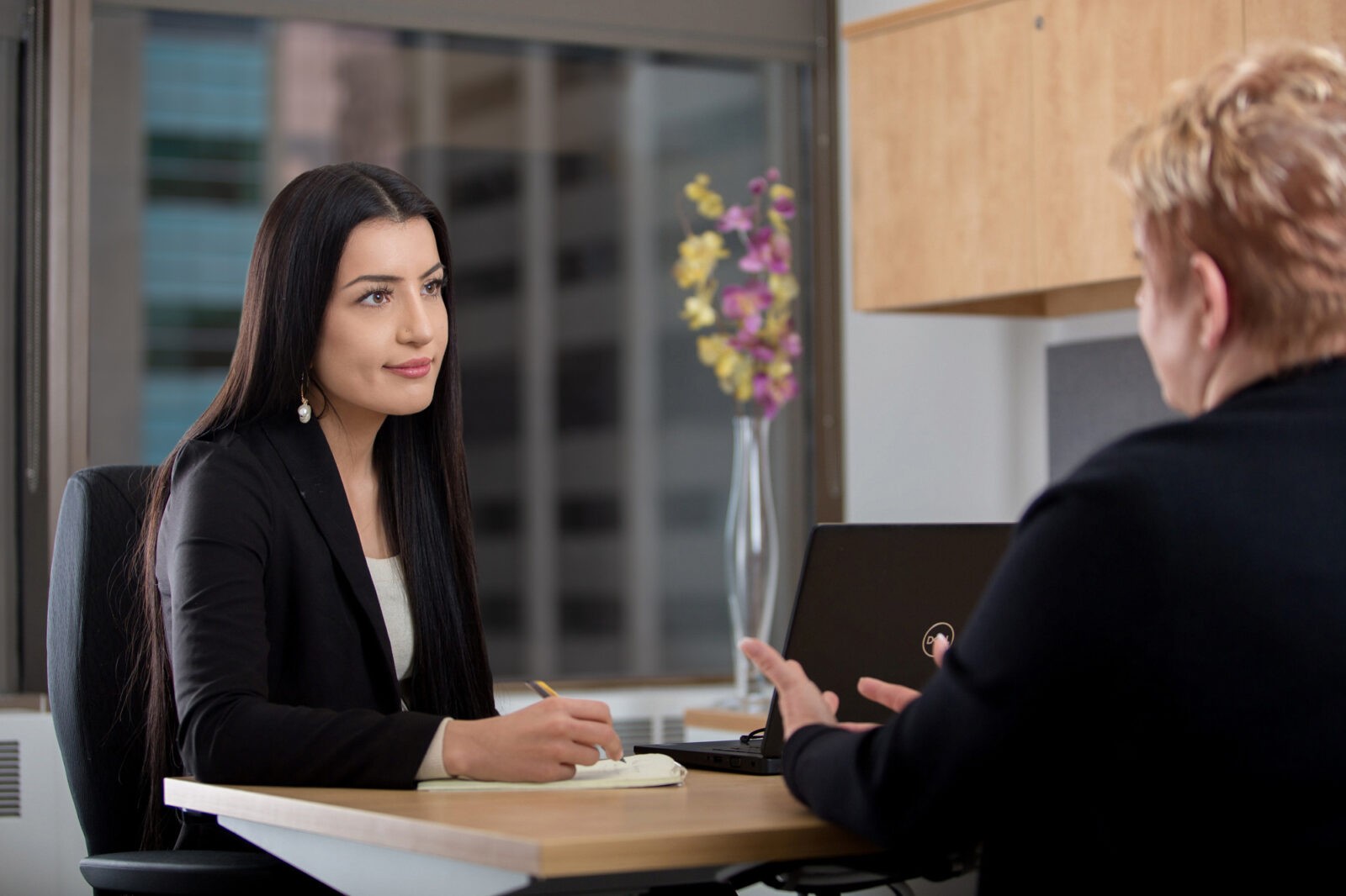 A young businesswoman talks to a client.