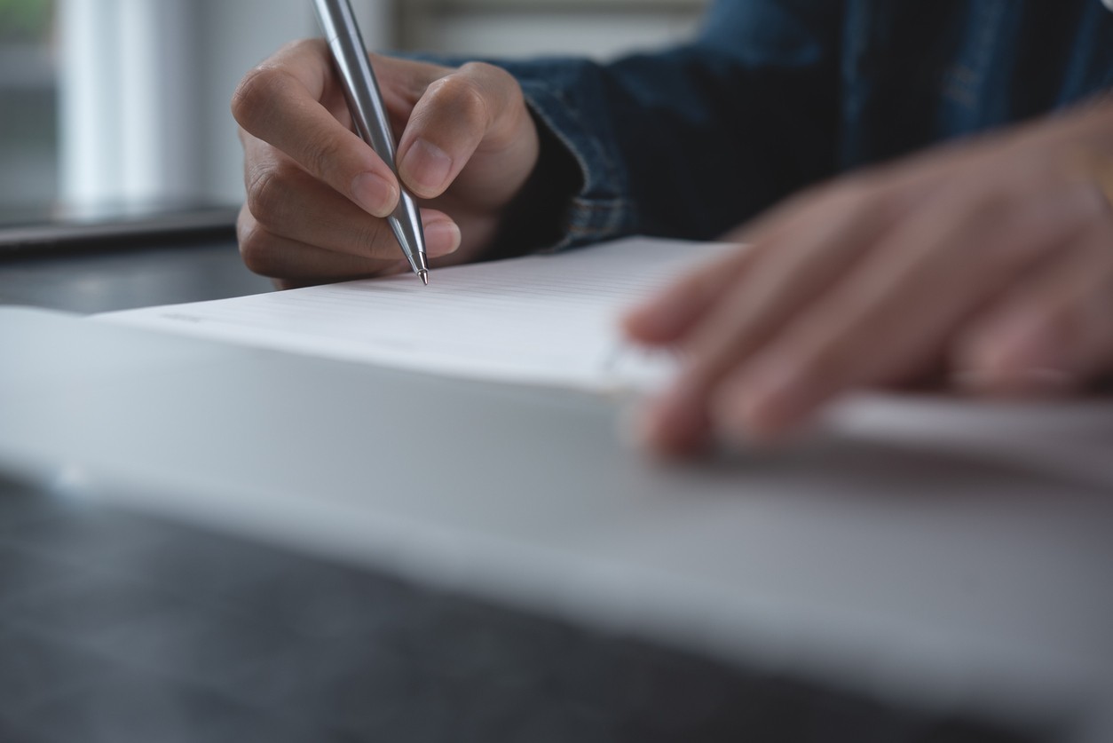 Person writing on paper
