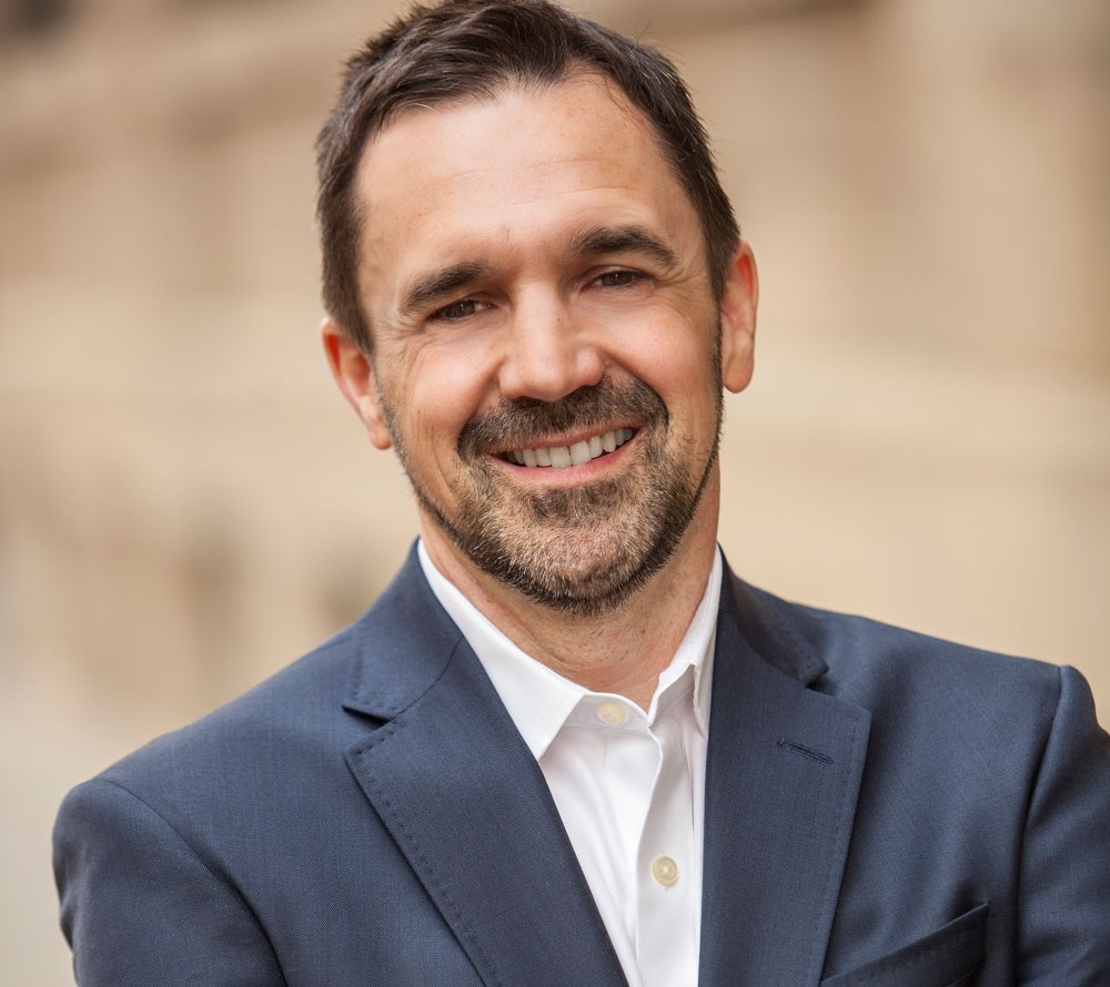 Headshot of Legal Aid Alberta CEO and President John Panusa smiling at the camera