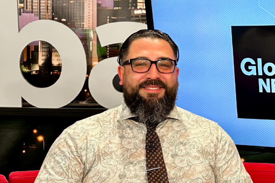 Smiling photo of Legal Aid Alberta lawyer on the Global Edmonton morning show tv set